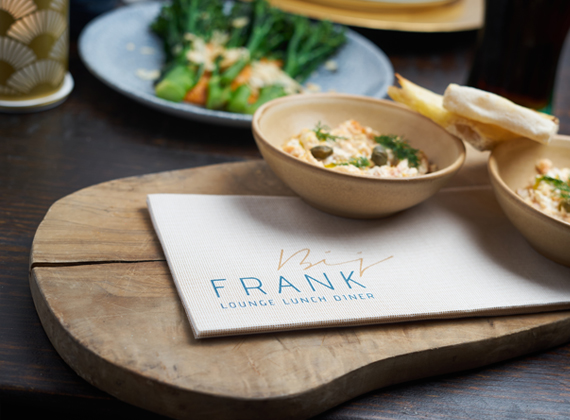 Custom printed napkin on a restaurant table served with food