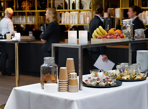 Breakfast buffet in a hotel with table covers and cups