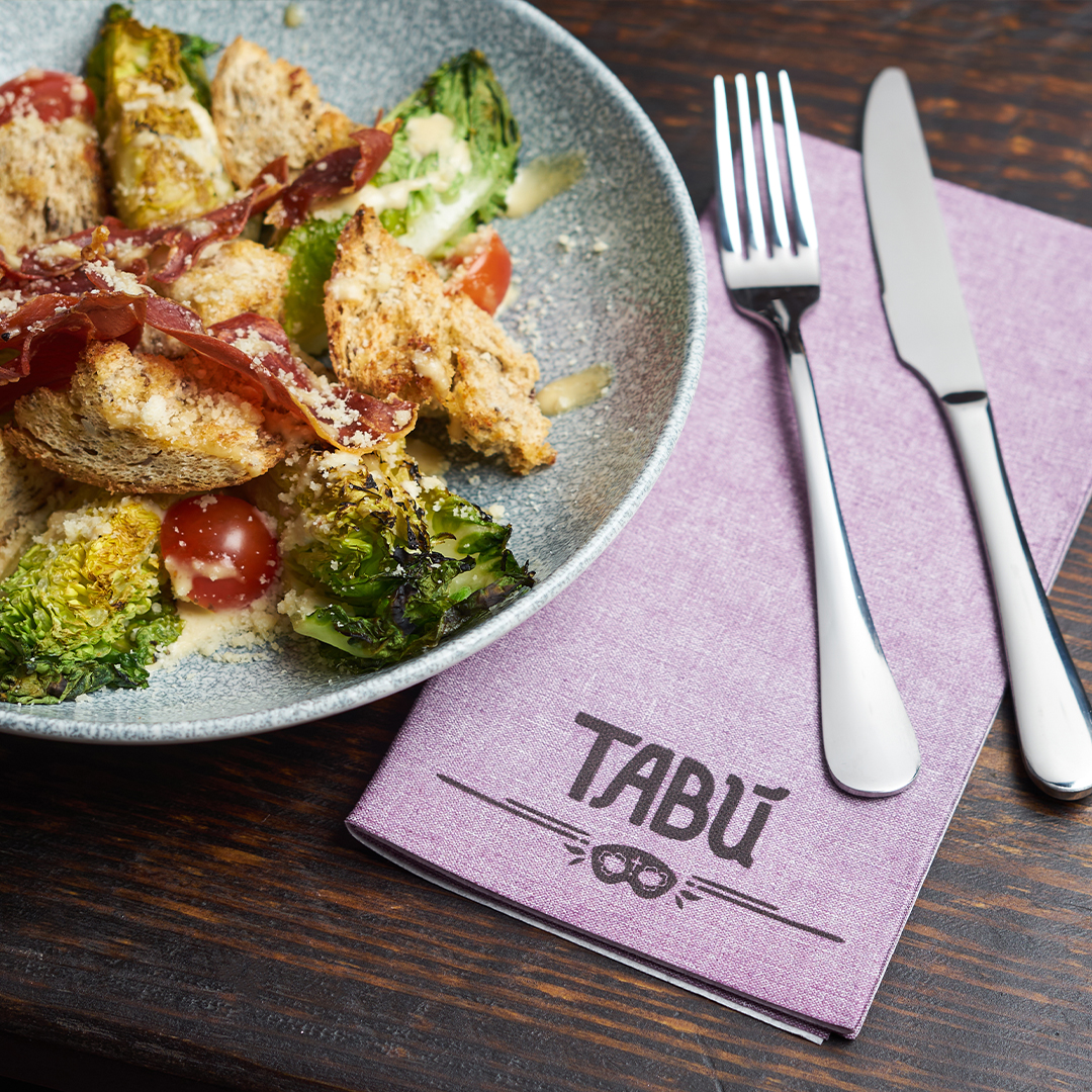 Purple branded custom napkin with logo next to food.jpg