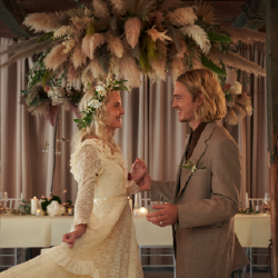 A couple at a wedding in front of a set table